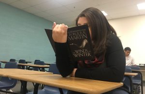 Before the start of first period, Whitney Bryan, 11, buries her nose with anticipation for the critically acclaimed “Winds of Winter.” Photo by Giana Haynia