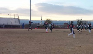 With her team positioned to score, quarterback Heaven Lucero, 12, looks for an open receiver. Photo by Sara Seibel