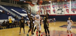Senior Nick Kornieck attempts to grab the rebound and help win the game after Bonanza tries to score a basket. (Photo by Karriem Beyah)