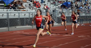 During heat two of the 100 meter hurdles, women’s varsity runners take their final steps completing their race. Photo by Meagan Young