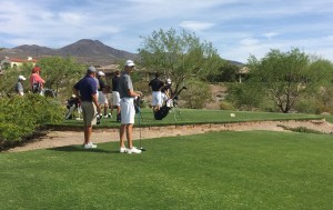 Playing close attention, members of the golf team watch as Faith Lutheran players take their turn putting the ball. Photo by Faith Evans