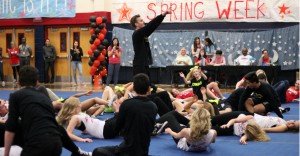 The senior boy band collapses onto the floor with varsity dance and cheer after their final number, “We’re All in This Together.” Photo by Mia Fortunato