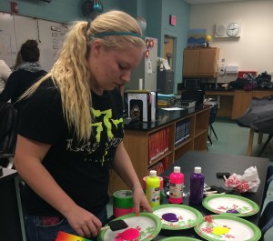 As a member of the decorations committe, senior, Chelsey Honrud , creates a poster for the annual Sadie Hawkins Carnival hosted by NHS.  (Photo by Karen Pegueros)