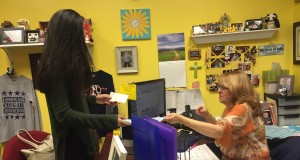 Paying for her AP exam, sophomore student Yasmine Yusof goes to the banker’s office to ensure a test for her. Photo by Regina Dispa