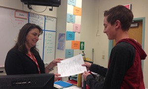 After selecting his electives for next year, Taylor Darden, freshman, gives his form to Miss Lee to sign. (Photo by Catelin Owens)