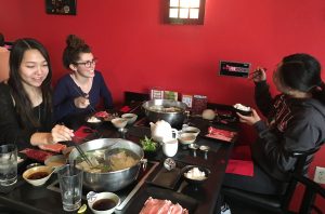 After receiving their food, juniors Sara Seibel, Saveria Fareno, and Sae Adachi exchange squeals of joy as they prepare to devour their food to calm their hunger. Photo by Karen Pegueros