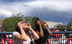 Wearing special glasses, Lisa Blair, 12, and Alexis Washington, 11, view the partial solar eclipse during their AP Environmental Science class.