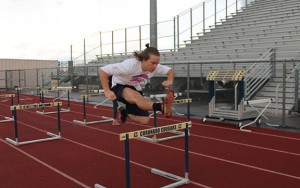 Jumping over the hurdle during intramurals, Ryley Kimball, 11, practices as if he were racing in an actual track event. Photo by Karen Pegueros