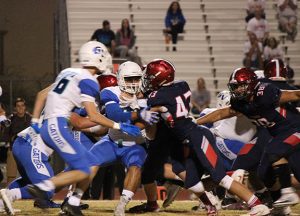 Defending against the Gator's offense, the Cougar defensive line blocks to give quarterback Landen Rowland, senior, time to make the play. 