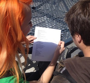 Tia Noll, senior, shares a pocket poem with Josh Nona, senior. (photo by Ashly Riches) 