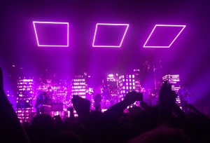 Known for their beautiful stage light setup during shows, The 1975 perform “UGH!” as their logo illuminates above them. Photo by Lexi Lane