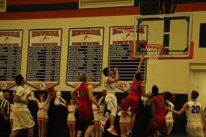 Bryce Savoy, 12, tips the ball in for a rebound shot, scoring 2 points for the Cougs. Photo by Tayler Dickerson