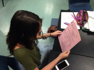  Before first period, Kaeli Bauman, 9, researches possible summer school courses that can be taken online. Photo by Maddie Baker