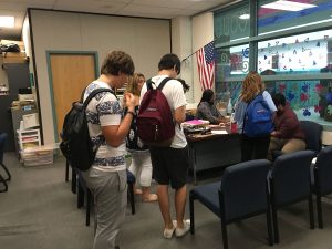 Seconds after the first period final bell, students line up to receive tardy passes from Mr. Hernandez, teacher volunteer, to be admitted into class. Photo by Ryan Kelleher