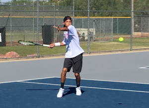 During a match, Philip Potamitis, freshman, returned a hard hit against his Silverado opponent. Photo by Ryan Kelleher