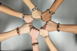Uniting to spread awareness on the importance of education, students buy Yuda Bands from Key Club. Photo by Saveria Farino