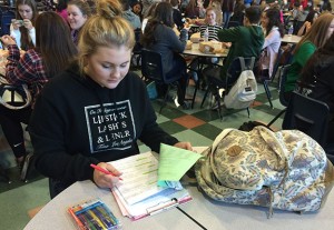  Studying her color coded and highlighted notes, Sydni Fredricks, 11, prepares for her upcoming tests. Photo by Meagan Young