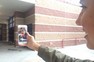 Trying to keep her 100-day snap streak going, Karen Pegueros, 10, takes a selfie using the dog face filter to snap to her best friend. Photo by Karissa Erven