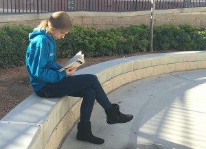 To enjoy the science fiction novel, “The Land Ironclads,” Bridgette Brown, 10, reads quietly during lunch. Photo by McKenna Cooley