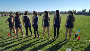 Waiting for their race to begin, the women’s cross-country team reflects on their accomplishments over the past season. Photo Courtesy of Megan Denter. 