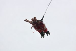 Exhilarated juniors Tristyn Yergensen, Garrett Loveland, and Nate Hawkes soar in an adrenaline-packed moment on the Dive Devil at Six Flags. Photo courtesy of Saveria Farino