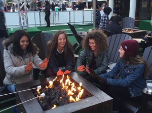 Taking a break from ice skating at The Ice Rink at the Cosmopolitan Hotel, freshmen Sage Tippie and Rayne Hayes and sophomores Saveria Farino and Regina Dispa, warm up their hands around the fire. Photo courtesy of Regina Dispa