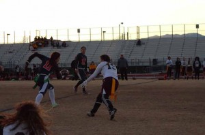 During Monday night’s varsity flag football game, Trinity Rhoades, 11, maneuvers around an approaching Eldorado player. Photo by Saveria Farino