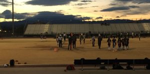 At the start of the game, the Cougars and Rattlesnakes face off for the first pike as the sun sets. Photo by McKenna Cooley 