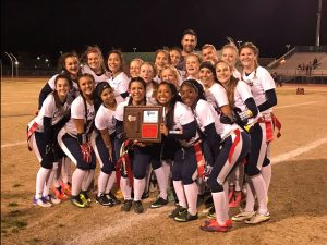 Still excited from their win, the varsity flag football team poses with their new Regional Championship plaque. Photo courtesy of Mr. Piccininni