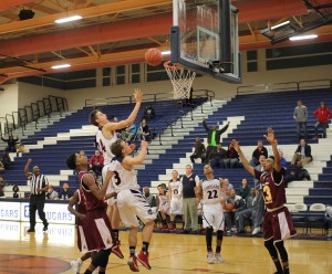 Jake Desjardins, 10, goes up for the basket while Braden VanAlfen, 11, waits for the rebound in last night's game against Eldorado High School.  (Photo by Emma Czerwinski)