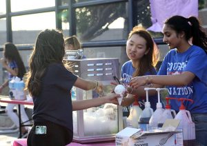 StuCo members make snow cones with favored toppings for future students at the Freshman Festival. Photo by Bekah Denny